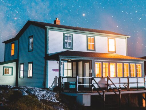 A house with the lights on at night.