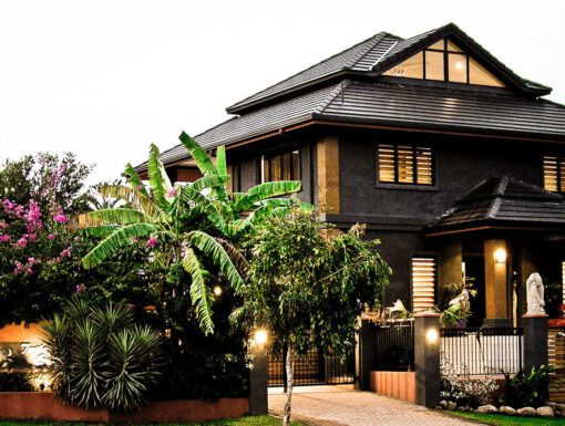 A large house with many trees and plants